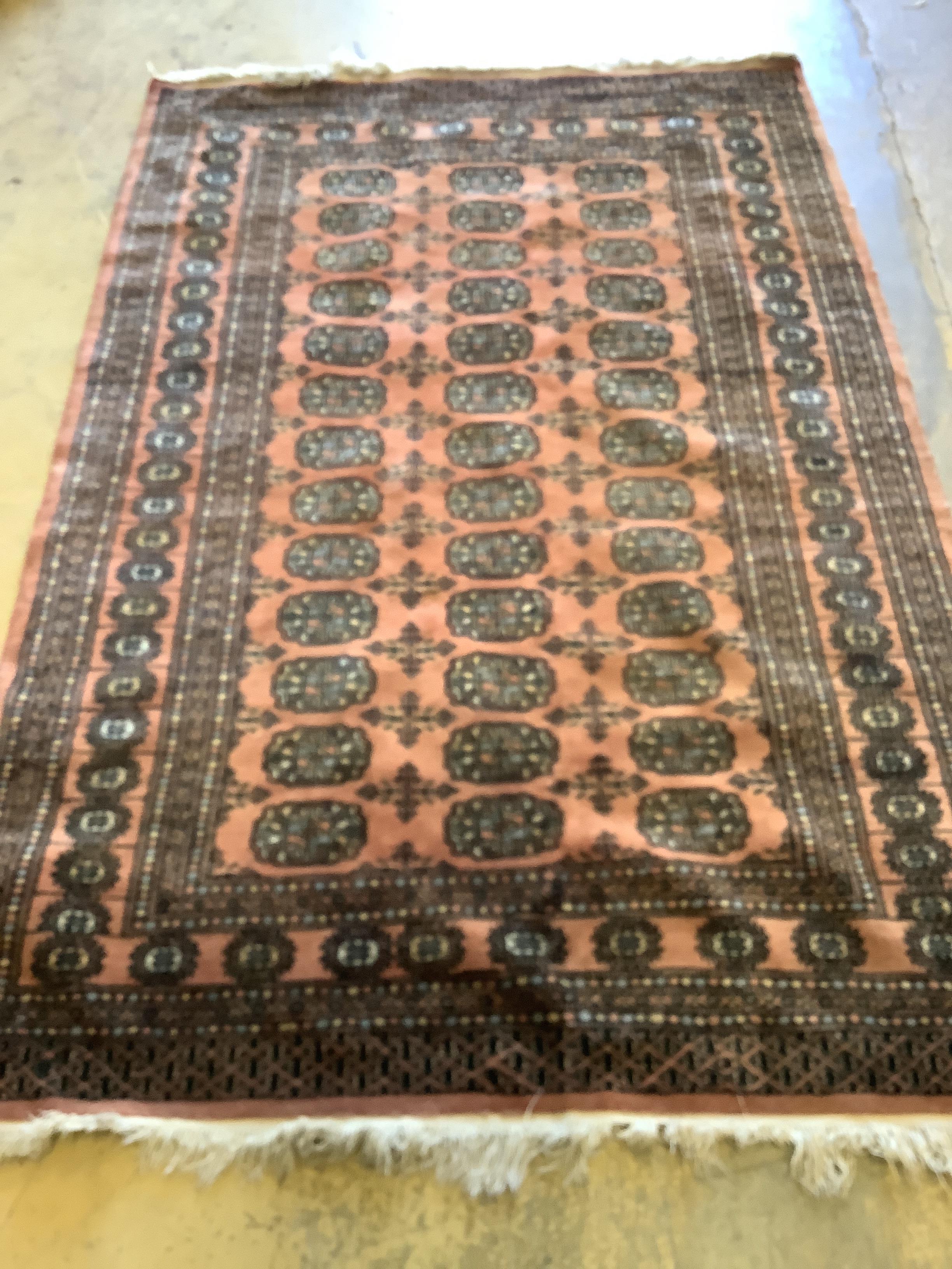 A Bokhara peach ground rug, 190 x 124cm